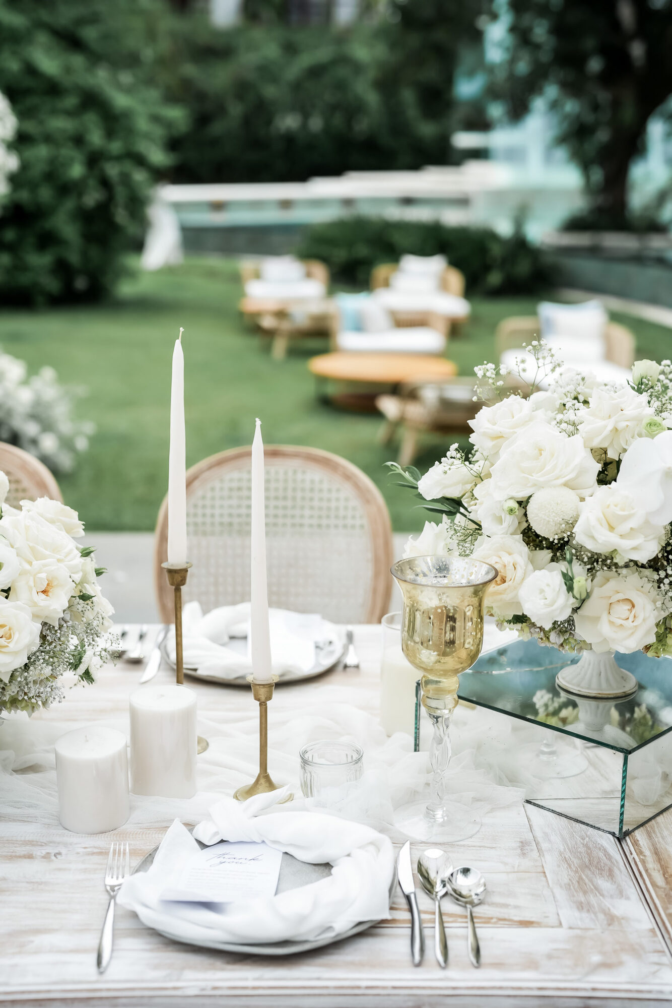 Candlelit reception table styled with white florals