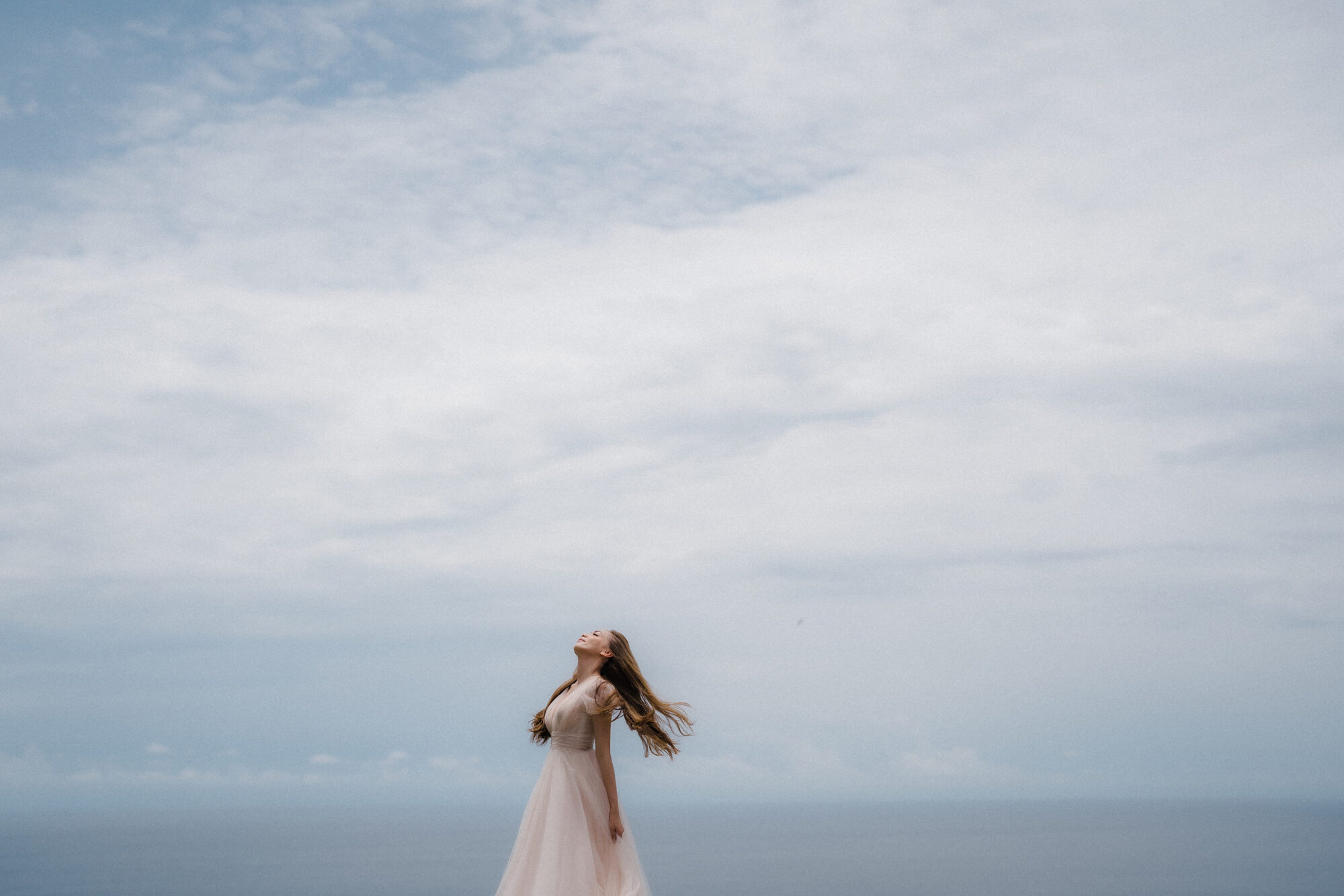 A bride against the open Bali sky